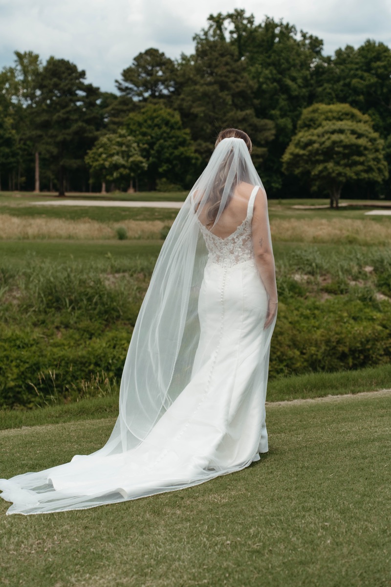 Bride in her veil on the lawn